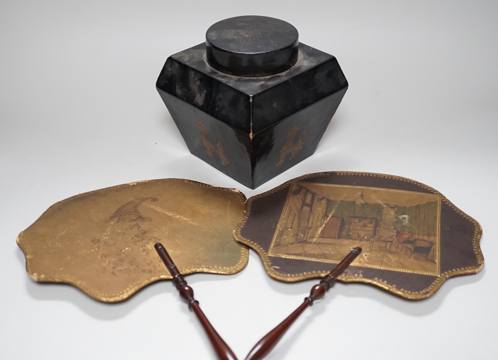 A pair of 19th century face fans, 36cm high, and a black lacquer tea caddy